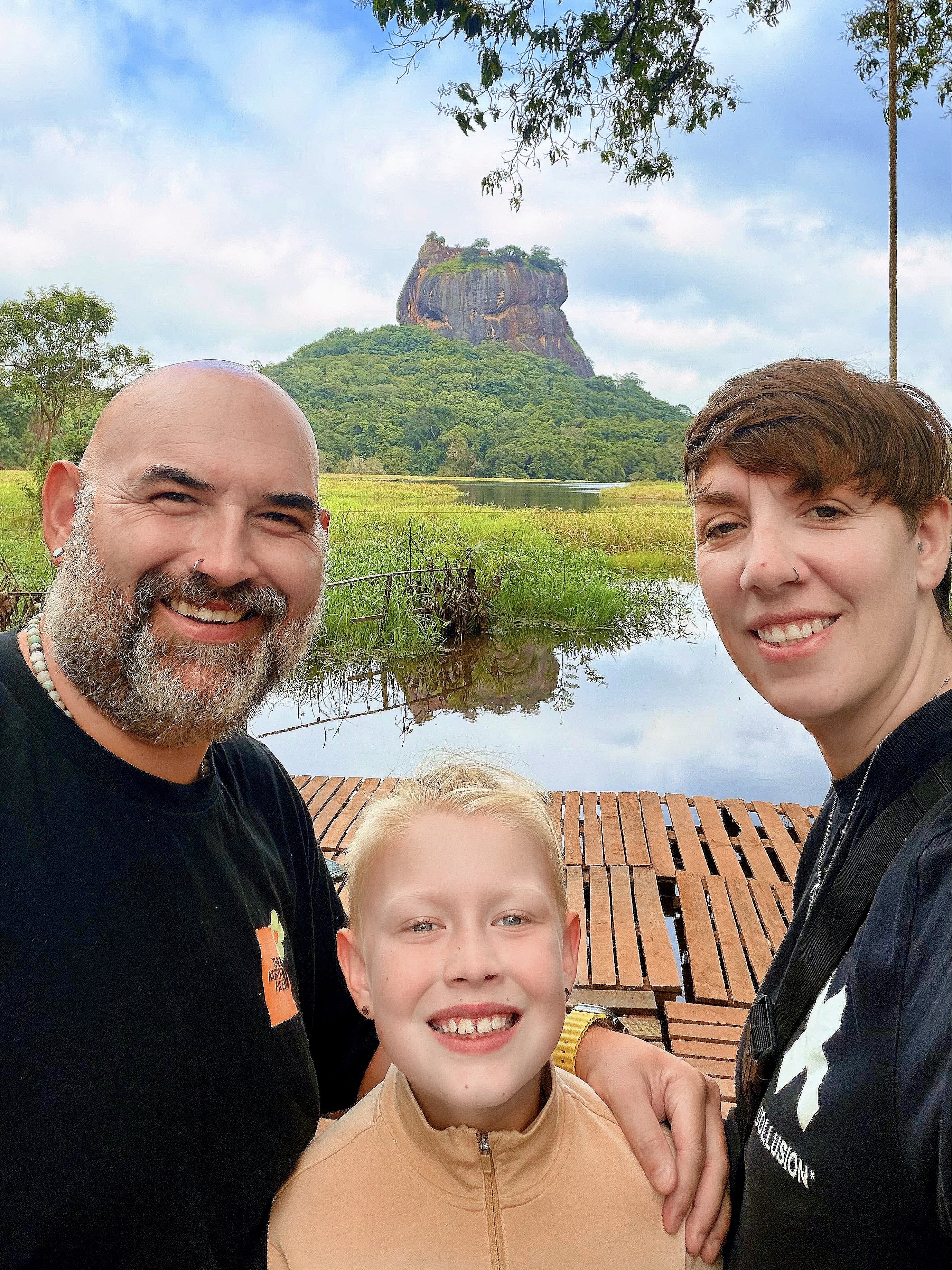 Jax Family Travels at Sigiriya Lions Rock, Sri Lanka, smiling in front of the famous rock